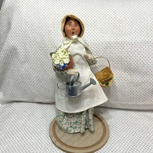 Byers Choice Ltd.  The Carolers lady with basket, flowers and watering can.
